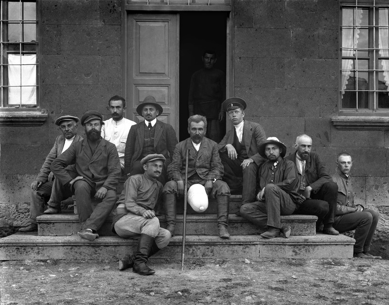 This photograph captures many prominent participants of the archeological expeditions in Ani led by Nikolai Marr. From left to right: first row: P. Knyagnitski, Ashkharbek Kalantar, Yu. Strume, Yu. Smirnov; second row: Nikoghayos Adonts, V. Beridze, Nikolai Marr, A. Andronikov, Aram Vruyr, Joseph (Hovsep) Orbeli.