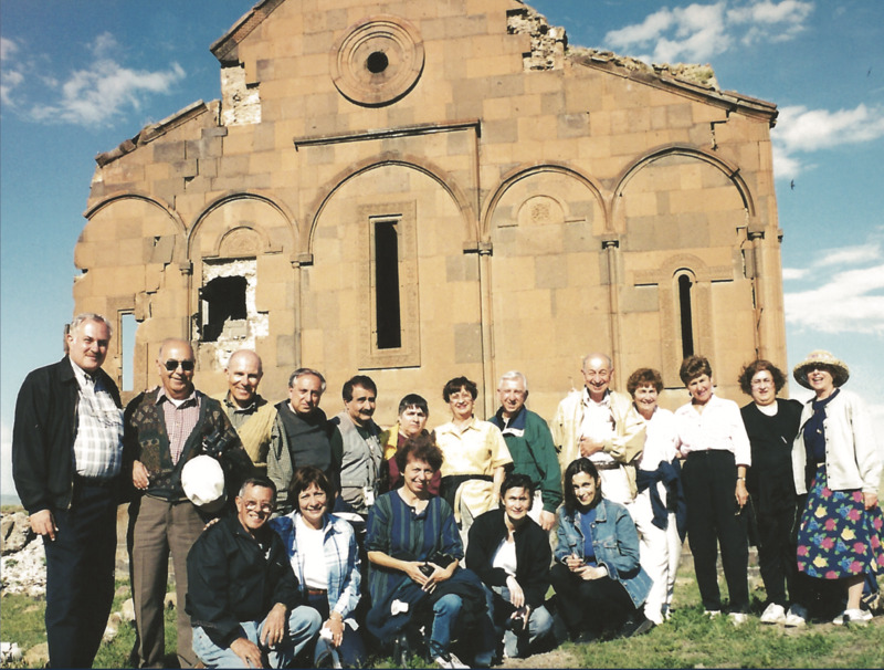 Armen Aroyan was an Egypt-born Armenian-American, an engineer by education and the long-time choirmaster of the Armenian Evangelical Cilicia Church in Pasadena. From 1987 to 2018, Aroyan organized around a hundred group tours for 1480 travelers, largely Armenians, to Anatolia, including to Cilicia and Historic Armenia. In addition to well-known sites, among them the ruins of Ani being very popular, these visits included villages and spots that connected with the family stories of the travelers oftentimes linked with the 1915 genocide against the Armenians. Aroyan fervently documented these trips with his handheld camera. In 2019, he donated the recordings – over 300 videos, some 400 hours of footage – to the USC Dornsife Institute of Armenian Studies, University of Southern California. Aroyan also meticulously collected details about the trip participants and their reactions, including photographs, testimonies, and literary works. This rich archive was compiled into four bilingual (English and Armenian) volumes titled <em>The Pilgrim Speaks: An Armenian Discovery of Ancestral Roots</em> and were self-published by Aroyan.